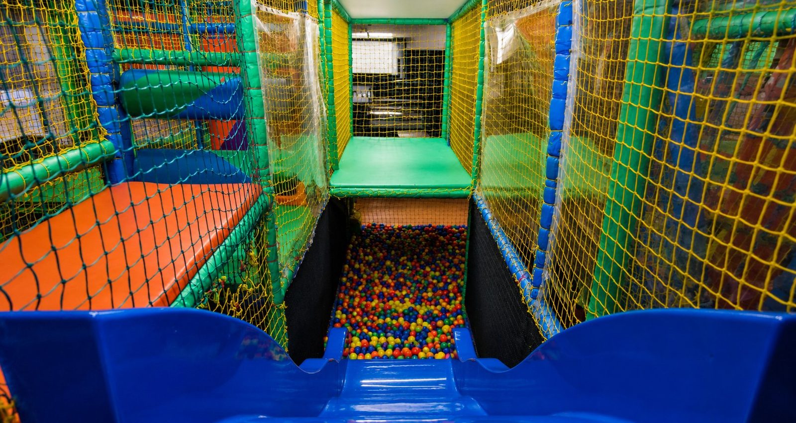 Slides into the ball pit at N20 KidsClub